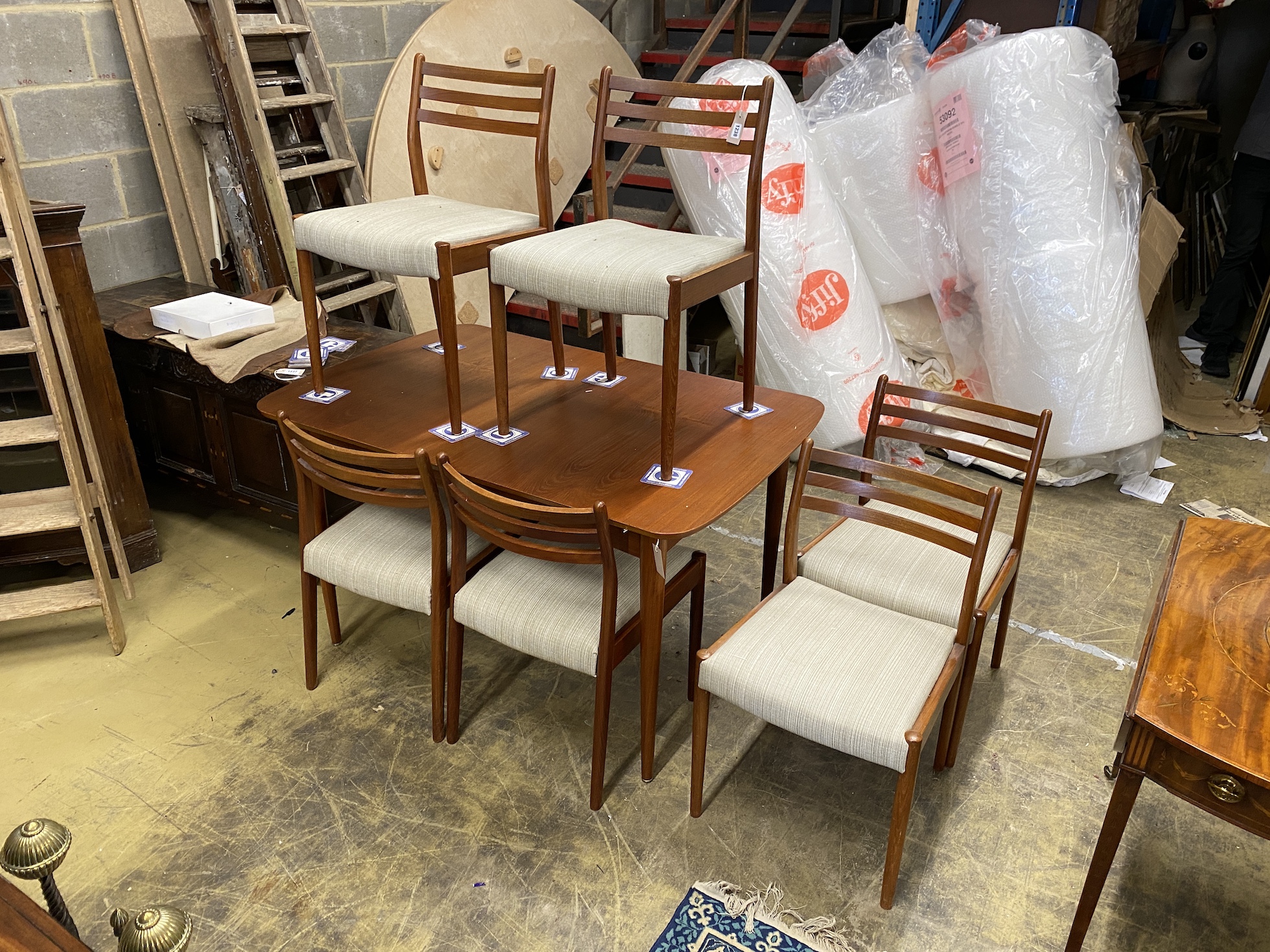 A mid 20th century Austin Suite teak extending dining table, length 130cm, width 84cm, height 73cm and a set of six matching bar back dining chairs